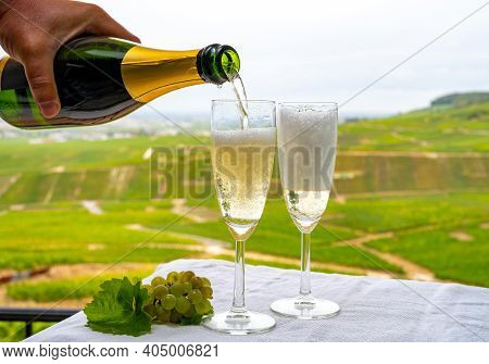 Tasting Of French Sparkling White Wine With Bubbles Champagne On Outdoor Terrace With View On Green 