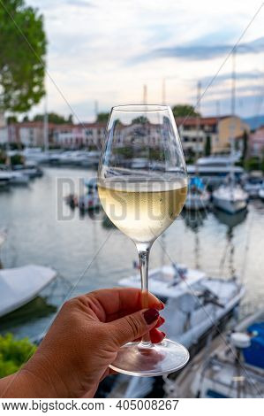 Tasting Of Local Cold White Wine In Summer With Sail Boats Haven Of Port Grimaud On Background, Prov