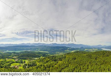 Austrial Landscape With Mountains, Forests And Alpine Lake Worthersee, Famous Tourist Attraction In 