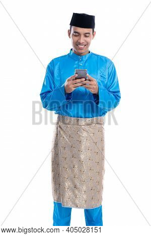 Asian Muslim Man With Mobile Phone Wearing Koko Melayu