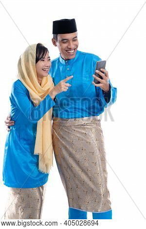 Muslim Couple Talk To Family Using Smartphone