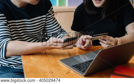 Happy Couple Shopping Online With Smartphone Laptopn And Creditcard At Home