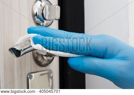 Man Hand In Blue Glove Cleaning Door Knob With Disposable Napkin Quarantine Time