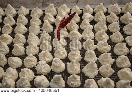 Daler Bori Is Being Dried On A Net In Sunny Day. It Is A Form Of Dried Lentil Dumplings Popular In B