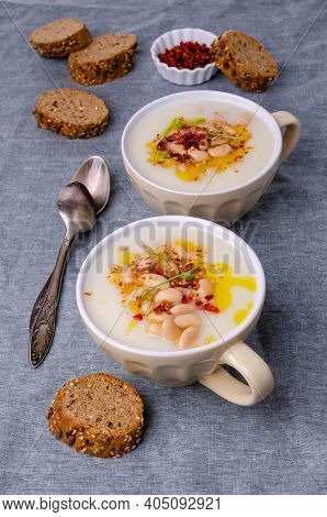 Vegetable Cream Soup With Beans And Spicy Oil In A Bowl On A Textile Background. Selective Focus.