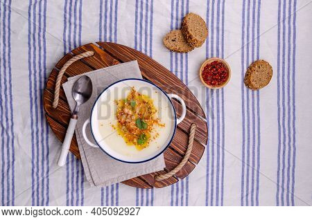 Vegetable Cream Soup With Beans And Spicy Oil In A Bowl On A Textile Background. Selective Focus.