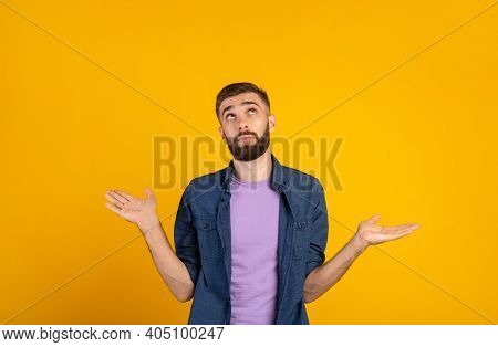 Who Knows. Confused Caucasian Guy Shrugging Shoulders On Orange Studio Background, Panorama. Uncerta