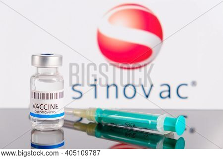 Sinovac Logo On The Background Of Bottle Or Vial With Vaccine And Syringe For Injection For Preventi