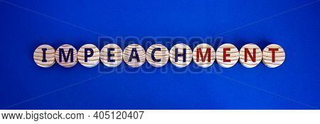 Impeachment Symbol. Wooden Circles With The Word 'impeachment'. Beautiful Blue Background, Copy Spac