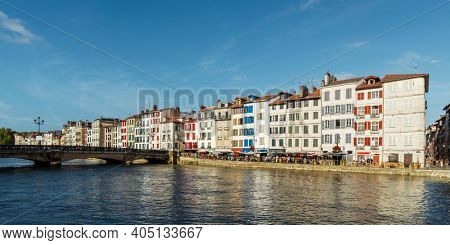 Colorful building facades along the Nive river, in Bayonne, France