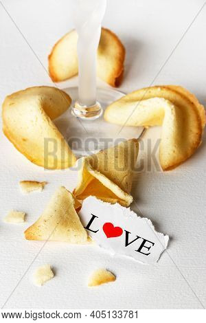 Cookies Shaped Like Tortellini With The Word Love Written On A Paper And A Glass Of Champagne.vertic