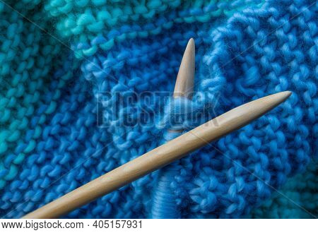 Wooden Knitting Needles Being Used To Knit A Woollen Blanket, With Copy Space