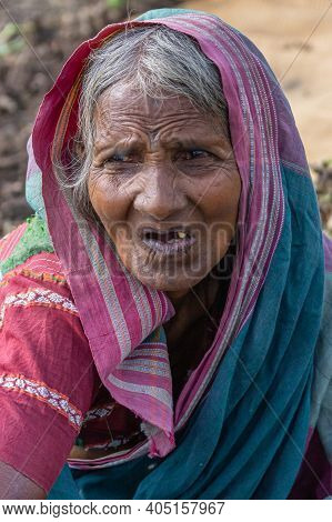 Abbigeri, Karnataka, India - November 6, 2013: Facial Closeup Of Older Female Peanut Harvester In Pu
