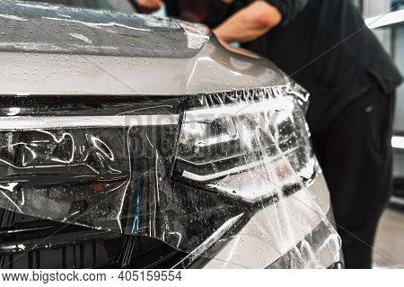 Transparent Paint Protection Film Or Ppf Or Anti-gravel Protection Coating Installing On Car Hood. C