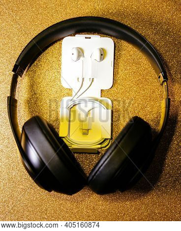 Paris, France - Oct 2, 2018: Apple Computers Earpods Headphones With Lightning Connector On The Gold