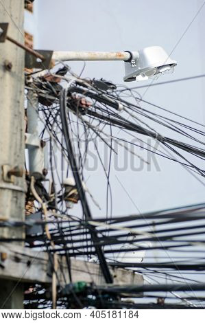 Chaos Of Cables And Wires On An Electric Pole