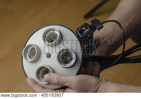 Man's Hand Holds New 4-lamp Holder. Softbox Holder, Photo Equipment, Continuous Lighting.