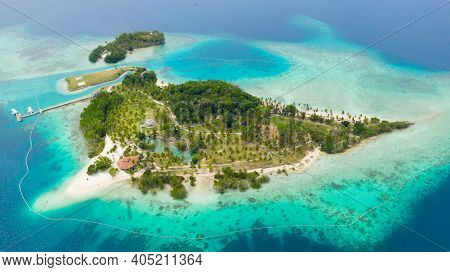 Aerial View Of Tropical Island With Sand Beach, Palm Trees By Atoll With Coral Reef. Malipano Island