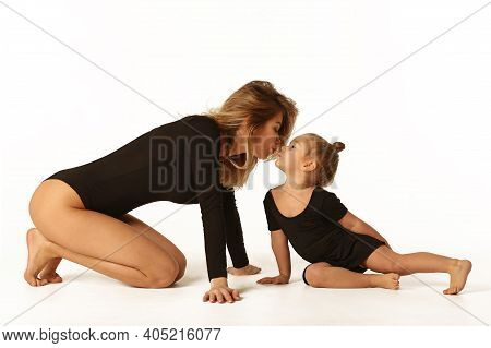 Cute Baby Girl And Mum In Black Bodies Having Fun Full Body Studio Portrait