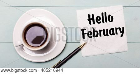 On A Light Blue Wooden Tray, There Is A White Cup Of Coffee, A Handle And A Napkin That Says Hello F