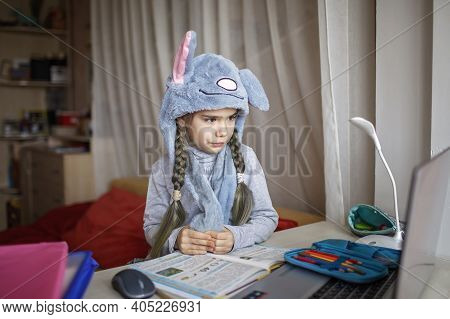 Distant Education, Online Class Meeting. Girl Wearing Funny Hat For Amusement During Online Lesson