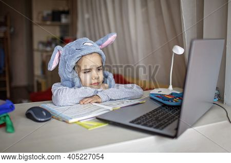 Distant Education, Online Class Meeting. Girl Wearing Funny Hat For Amusement During Online Lesson