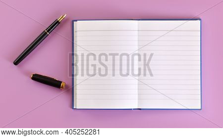 Top Down View - Black Fountain Ink Pen With Gold Nib, Opened Cap, Empty White Paper Pad On Lilac Boa