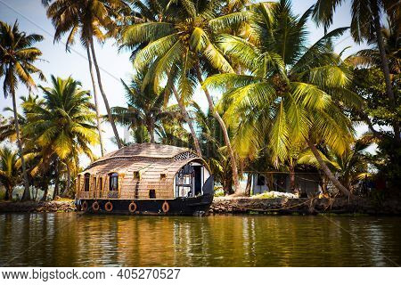 House-boat Pleasure Cruise Ship In India, Kerala On The Seaweed-covered River Channels Of Allapuzha 