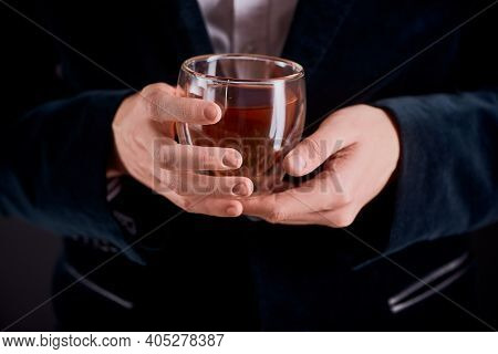 Tea Master Holding A Glass Cup Of Freshly Brewed Herbal Tea