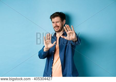 Guy Cringe From Something Disgusting Or Embarrasssing, Stretching Out Hands And Asking To Stop, Grim