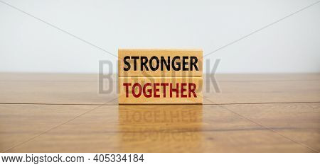 Stronger Together Symbol. Concept Words 'stronger Together' On Wooden Blocks On A Beautiful Wooden T