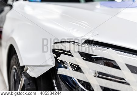 Wrapping The Car With Self-adhesive Foil. Changing Car Color