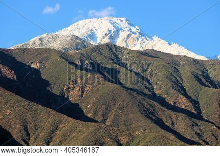 Barren Chaparral Covered Hills With Snow Capped Mountains Beyond Taken At Cucamonga Peak In The Rura