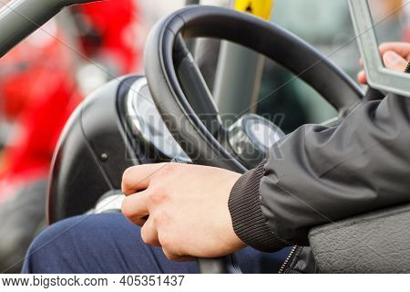 Man Operating Control Panel And Steering Wheel In Agricultural Or Industrial Machine, Part And Detai