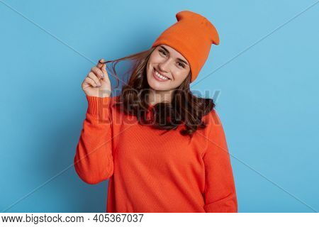 Closeup Portrait Of Young Happy Woman Smiling Isolated On Blue Background, Looks At Camera With Joyf