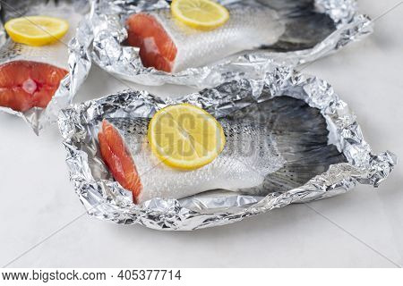 Fresh Raw Salmon Fillet Tail Part With Lemon On A Light Background. Pescatarian Food Menu, Recipe. R