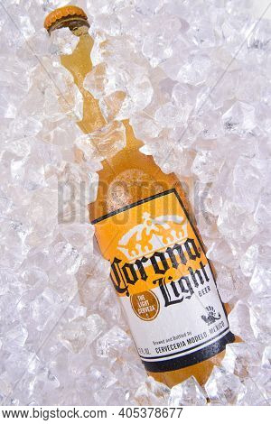 IRVINE, CALIFORNIA - MARCH 29, 2018: Closeup of a bottle of Corona Light beer bottle in ice. Corona is the most polular import in the USA.