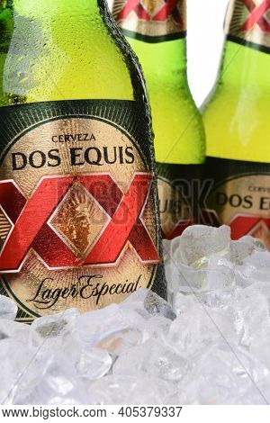 IRVINE, CA - MAY 30, 2014: Closeup of bottles of Dos Equis Lager Especial in ice. Founded in 1890 from the Cuauhtemoc-Moctezuma Brewery in Monterrey, Mexico a subsidiary of Heineken International.