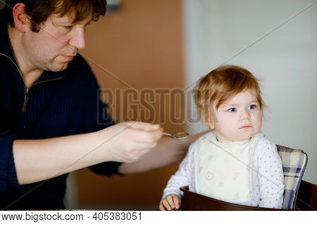 Father Feeding Baby Girl From Spoon Mashed Vegetables And Puree. Food, Child, Feeding And People Con