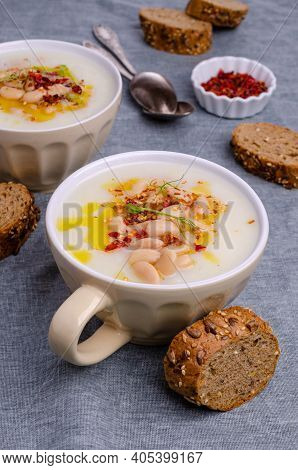 Vegetable Cream Soup With Beans And Spicy Oil In A Bowl On A Textile Background. Selective Focus.