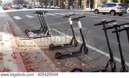 San Diego, California Usa - 4 Jan 2020: Row Of Ride Sharing Electric Scooters Parked On Street In Ga
