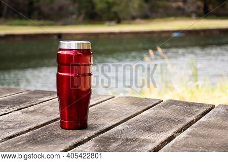 Insulated Reusable Stainless Steel Coffee Travel Tumbler Mug On The Wooden Table With Nature Backgro