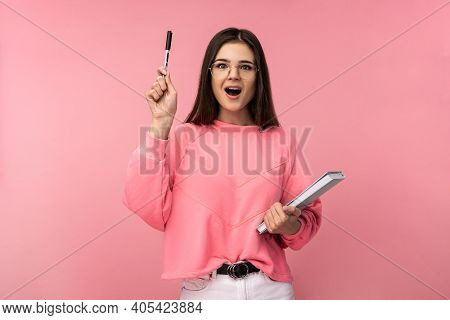 Photo Of Attractive Woman In Glasses Holds Book And Pencil, Looks Quick-witted. Student Got Idea. We