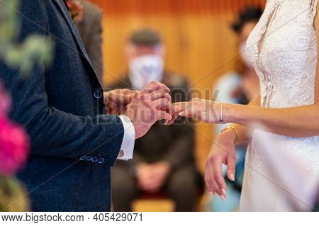 Bride And Groom Exchange Wedding Rings On Their Wedding Day