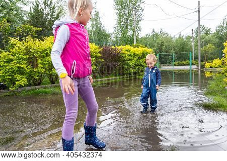 Pair Of Two Cute Blond Caucasian Little Children Brother And Sister Enjoy Have Fun Playing Jumping I