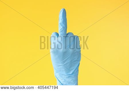 Hand In Rubber Glove Showing Middle Finger Closeup. Stop Coronavirus Concept