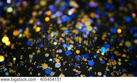 Defocused Shimmering Multicolored Glitter Confetti, Black Background. Holiday Abstract Festive Bokeh