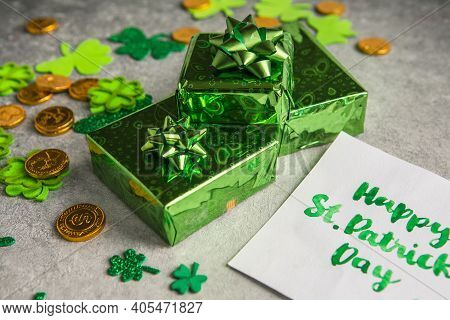 Decorative Clover Leaves, Green Gifts Box, Coins On Stone Background, Flat Lay. St. Patrick's Day Ce