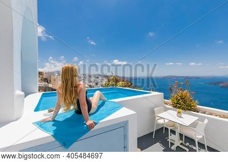 Young Woman On Vacation At Santorini, Women At The Swimming Pool Looking Out Over The Caldera Sea Of