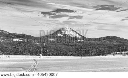 Winter Hilly Landscape Of Lusatian Mountains With Klic Mountain In The Middle. Czech Republic. Black